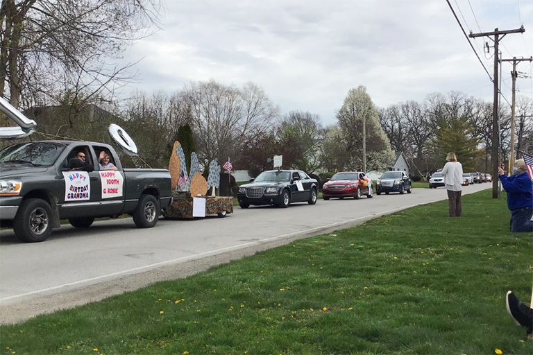 Parade vehicles, including Rosie’s grandson’s, go by.