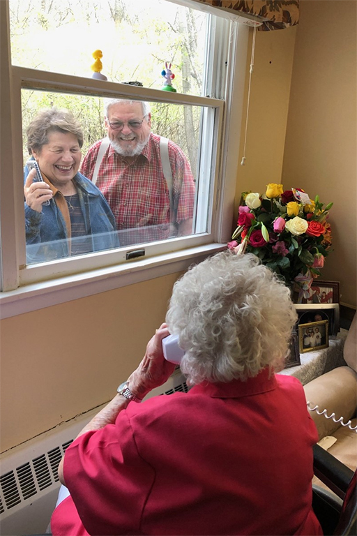 Rosie’s son, Bud, and daughter-in-law, Barb, visit at the window after the parade.