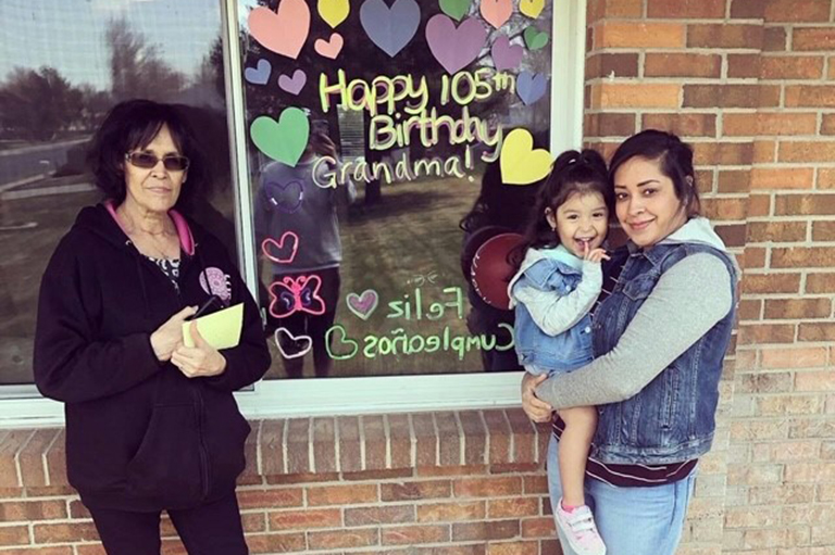 Maria’s family doing a window visit for her birthday