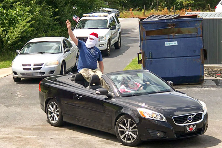 Santa waving near the rear of the parade 