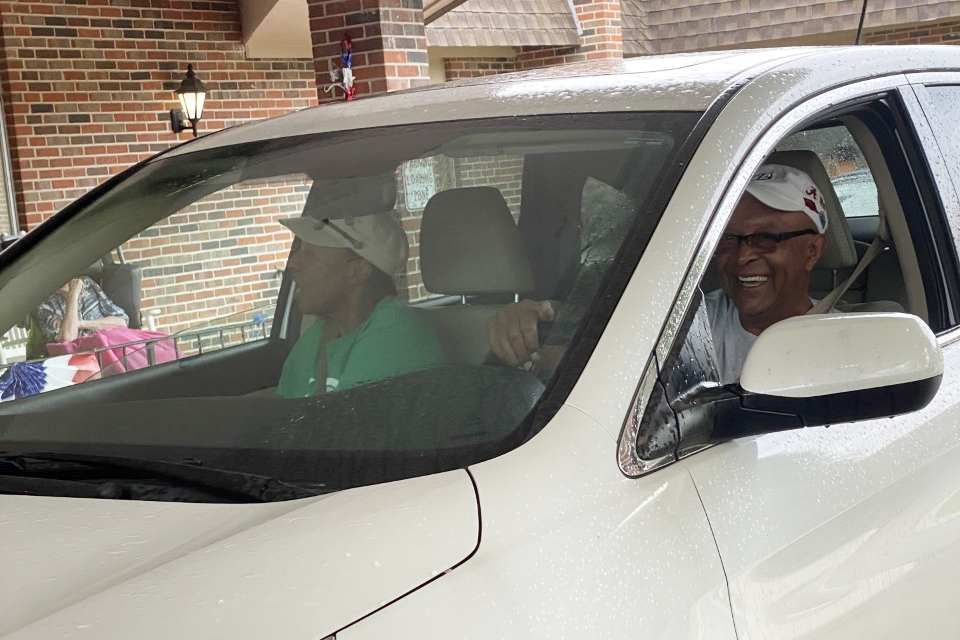 Family members smile as they visit their     loved one.