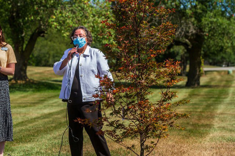 Chaplain Cathy dedicates the Japanese red maple tree.