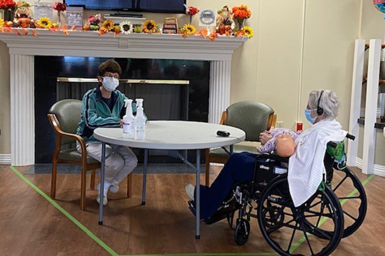 Judy Migliozzi visits with her mother, resident Theresa Allain.