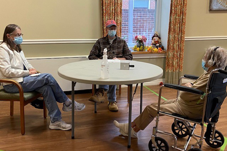 Resident Mildred Wilbur visits with her son, Rodney, and daughter-in-law, Victoria.