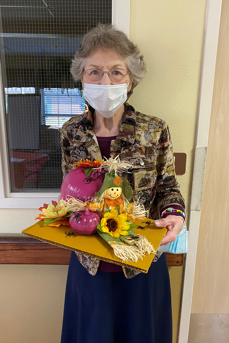 Resident Linda Ogle with her winning pumpkin design at The Heritage Center