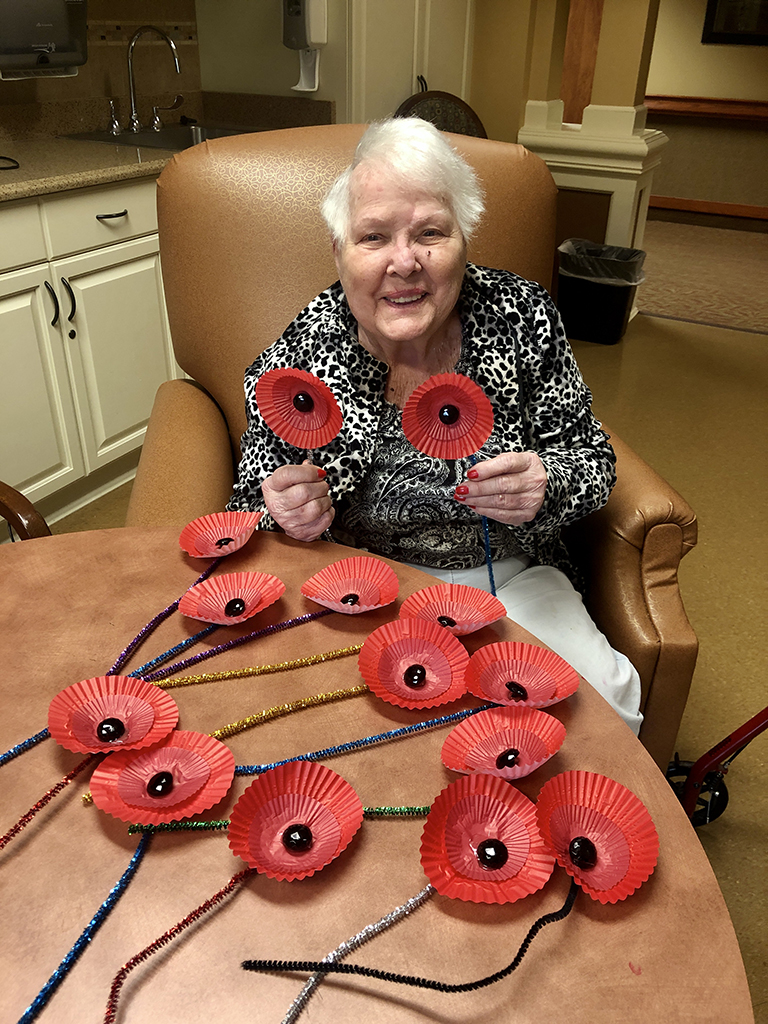 Resident Hattie Myers, a military wife, making poppies at Life Care Center of Blount County 