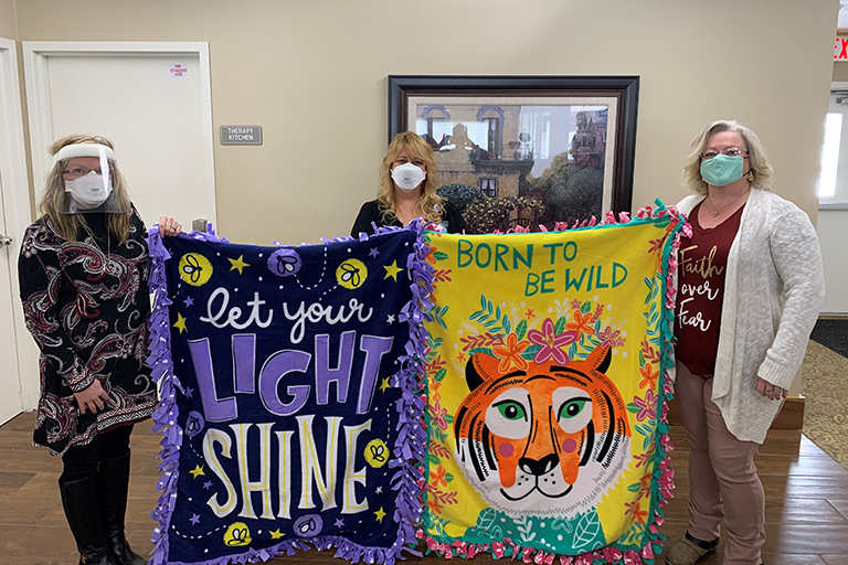 Wilma Litzau, business development director at Life Care Center of LaGrange; Gina Shepherd, activities assistant at Life Care Center of LaGrange; and Sherilyn Lackey, chapter president of Sleep In Heavenly Peace