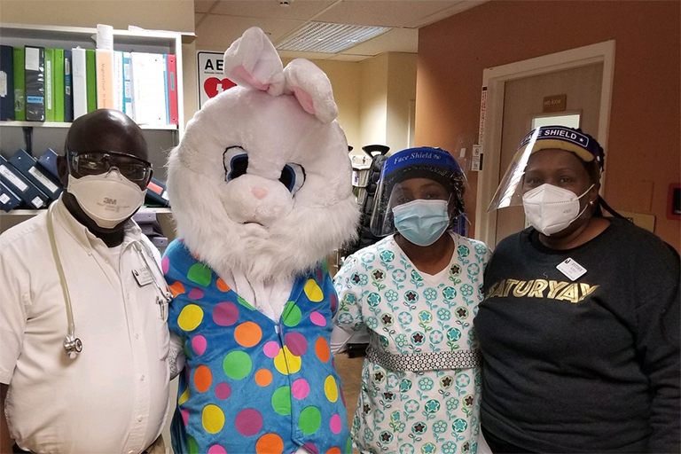 Left to right at Life Care Center of Auburn: Julius Babu, licensed practical nurse; the Easter Bunny; Jesula Jean, certified nursing assistant; and Esther Kuria, LPN