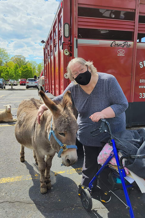 Resident Bonnie Hildebrandt at Life Care Center of Medina at the petting zoo