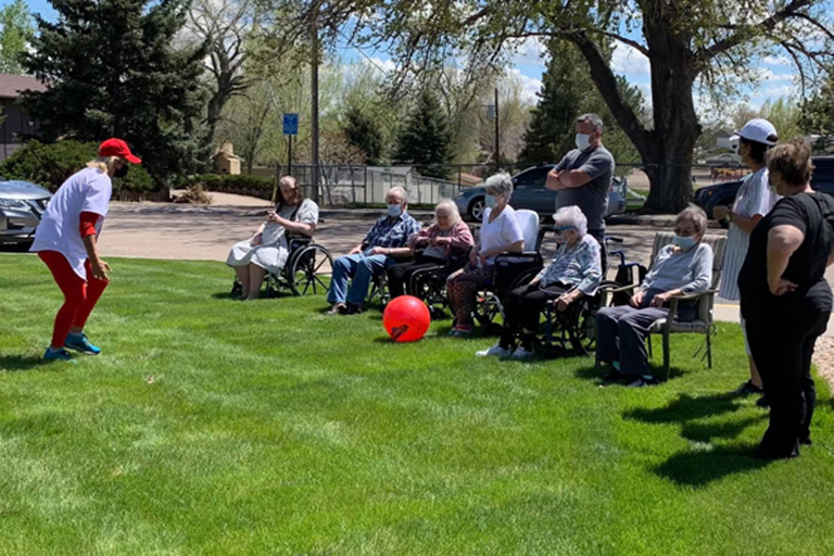 Associates and residents at Valley View Villa enjoying kickball