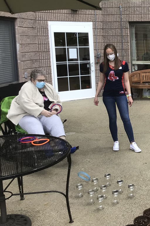 Life Care Center of the North Shore resident Gail McWalters and Casara Lane, activity director, playing a carnival game