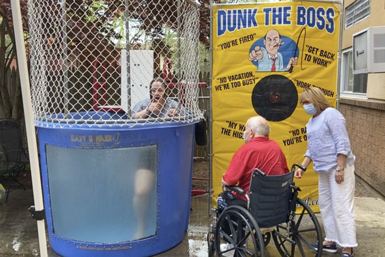 Evergreen House resident Joe Rossi and Jeannie Grant, activities assistant, just after dunking Nat Cushing, executive director