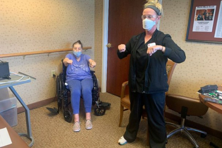 Resident Sheryl Howard participating in a Zoom class with Bethany Thompson, physical therapist assistant and coach