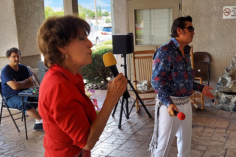 Elvis sings classic American songs to entertain residents. 