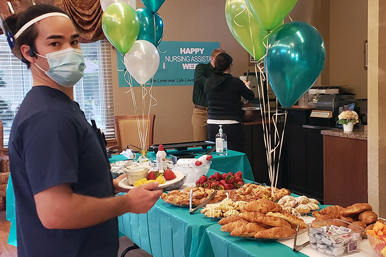 Kai Hays, CNA, checking out the breakfast at Kirkland