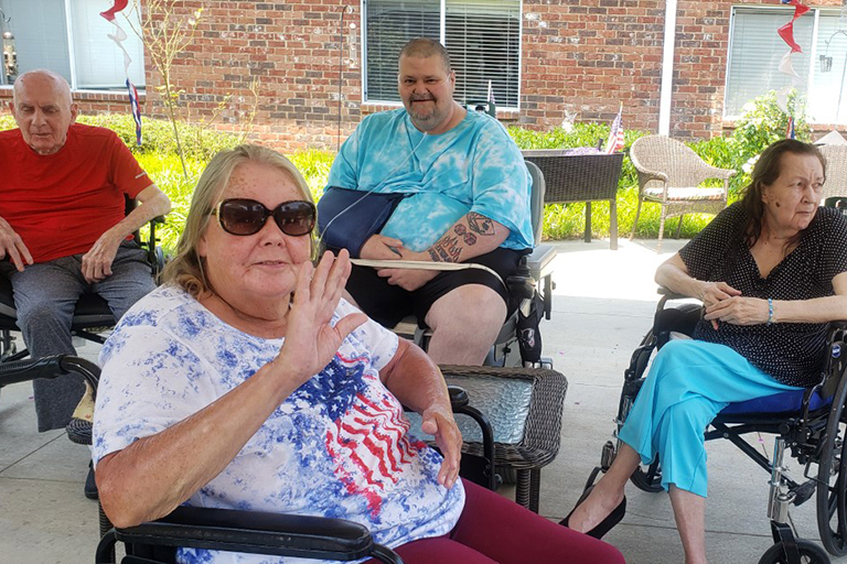 Hendersonville resident Carol Fischer waiving with (left to right) in the back: Jack Bell, Terry Bryant and Rosita Appel