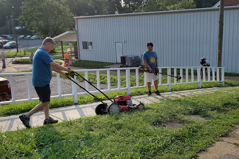 John Kitterman, vice president of purchasing, mowing, and Clemente Aquino, vice president of rehab practice standards, trimming