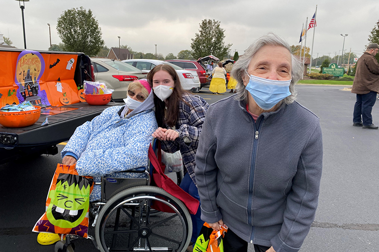 Residents Gail Halash (left) and Elinor Shanley (right) with Audrey Scibilia, activity assistant at Rivergate Health Care Center’s trunk-or-treat