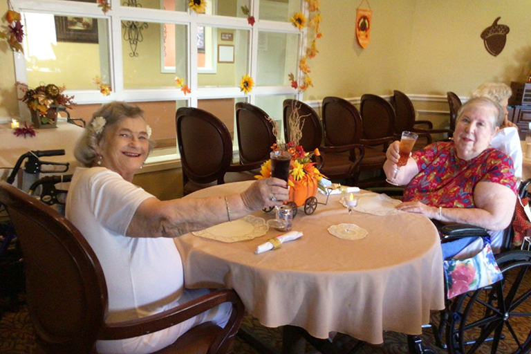 Residents Ann Slasor (left) and Martha Beere at the Thanksgiving meal at LCC Orange Park