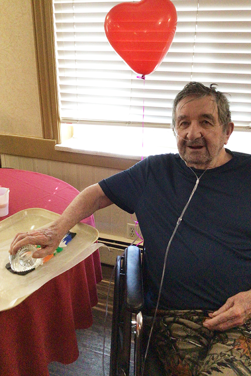 Cañon Lodge Care Center resident Charles Bell making clay hearts