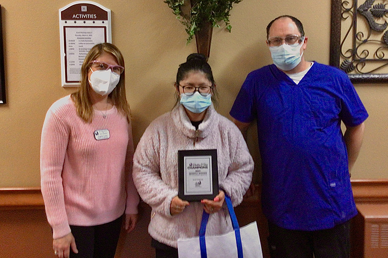 Ellie Thornton, cook/dietary aide, with Angela Cerna, executive director (left) and Robert Cornell, dietary manager