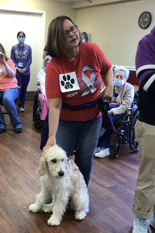 Linda Taylor, co-chair of the county’s Relay For Life, with her goldendoodle, Sophie
