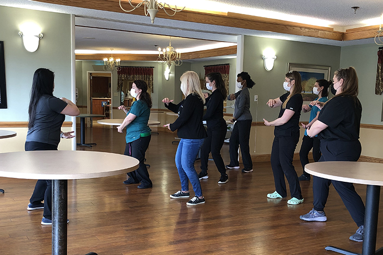 Associates participating in a tai chi session