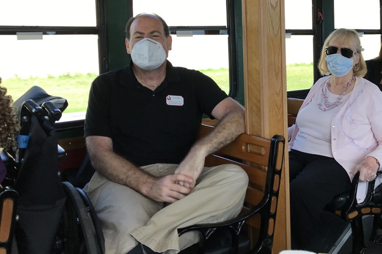 Steven Hechler, bus driver at The Gardens Court (left), and resident Corrine Cacioppo on the trolley