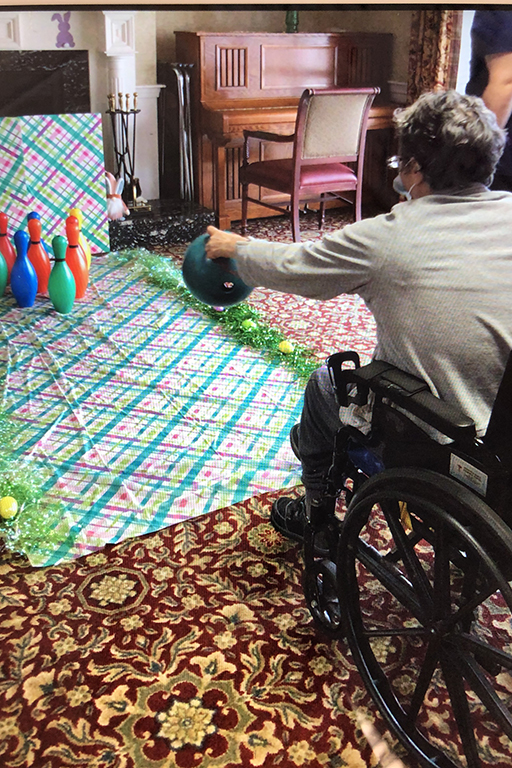 Resident Kate Hamilton bowling at Life Care Center of Merrimack Valley