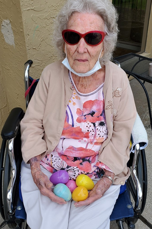 Resident Patricia Hailstone holding her Easter egg collection at Life Care Center of Osawatomie