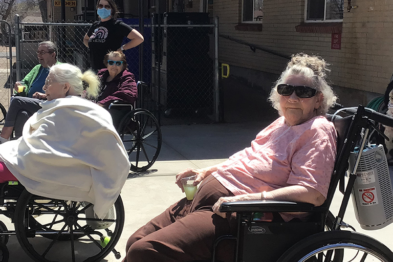 Cañon Lodge Care Center resident Sheila Heinze enjoying the sunshine and lemonade during the Easter egg hunt