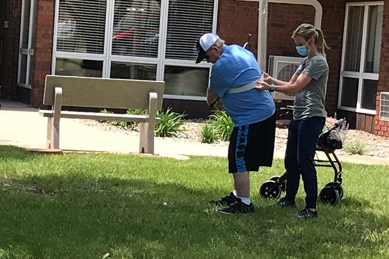 Bruce practicing golfing in rehab