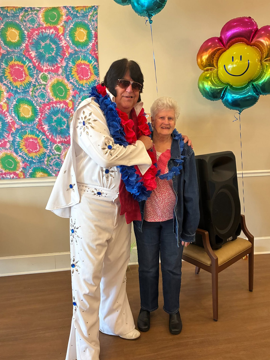 NALW.jpg Elvis impersonator standing with a smiling senior
